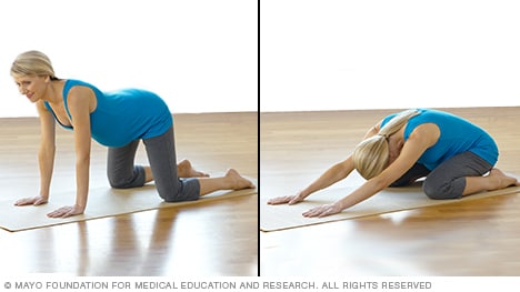 Pregnant person doing a backward stretch