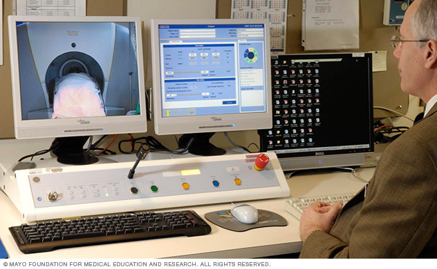 Radiation oncologist monitoring Gamma Knife procedure in progress.