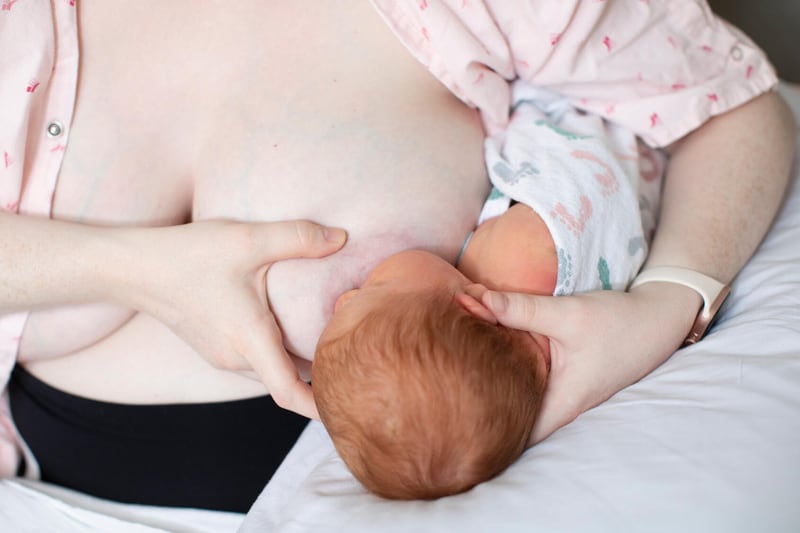 Woman breastfeeding with football or clutch hold