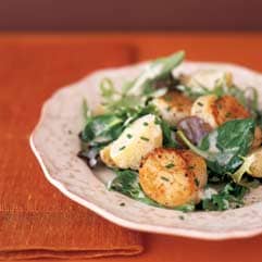 Seared scallops with new potatoes and field greens 
