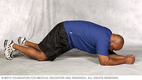 Man doing modified plank core-strength exercise