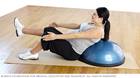 Pregnancy exercises &mdash; pregnant woman practicing a v-sit supported by a balance trainer