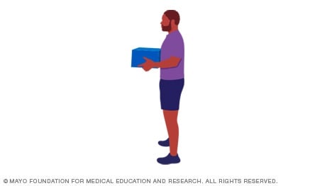 A person holding a box while standing