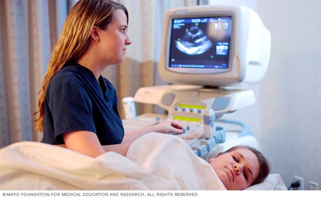 A person conducts an echocardiogram.