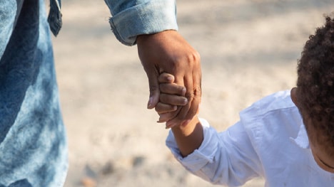 People holding hands on the beach