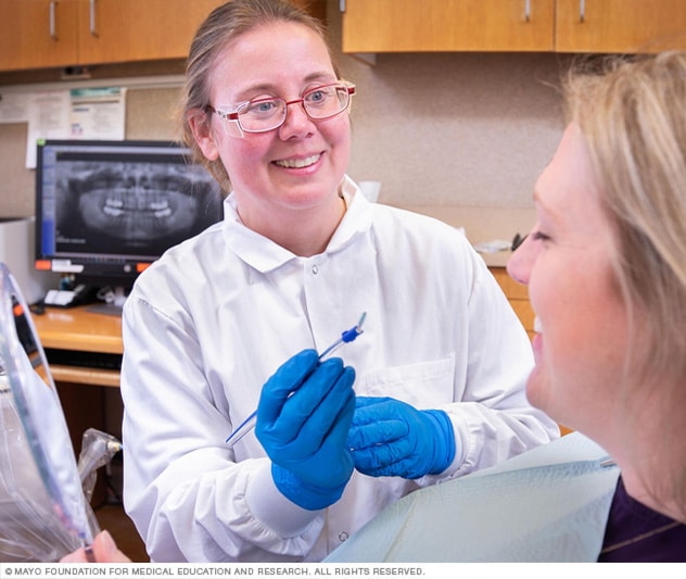 A dental hygienist goes over oral care instructions with a patient.