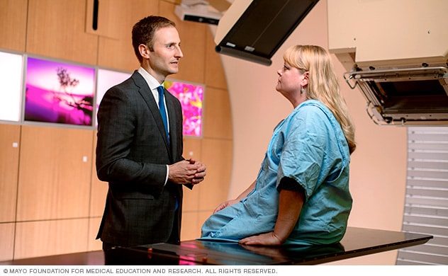 A doctor talking with a patient before radiation therapy