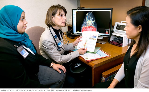 Specialists discussing care with a patient