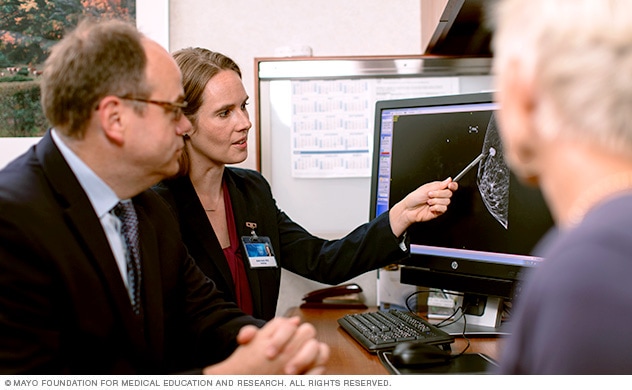 Image of doctor points out breast cancer lesion to patient