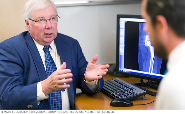 A Mayo Clinic surgeon explains treatment options to a patient.