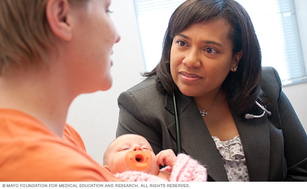 An obstetrics and gynecology specialist talks with a woman about her condition.