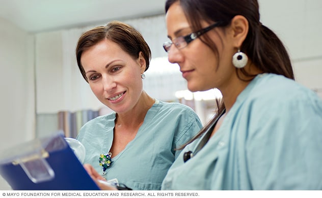 Obstetric-gynecology nurses review a care plan.