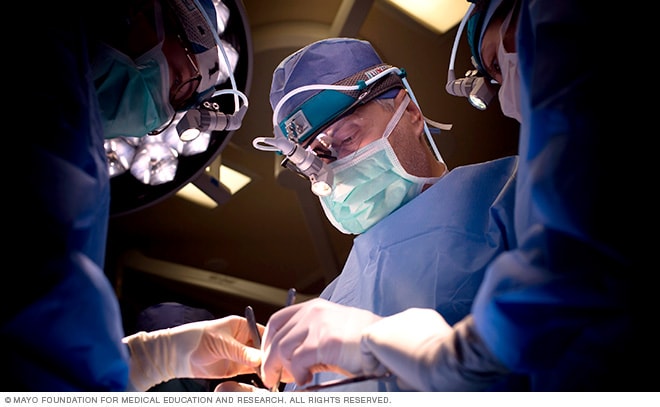 An otolaryngology surgical team operates