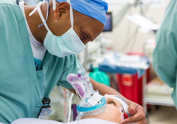 A physician reassures a pediatric patient before surgery