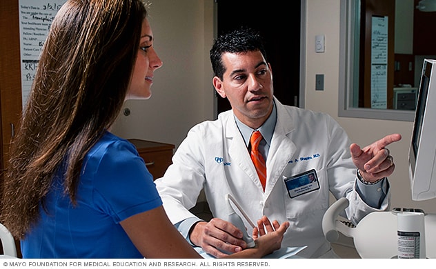 A Mayo Sports Medicine specialist consults with a person about her wrist injury.