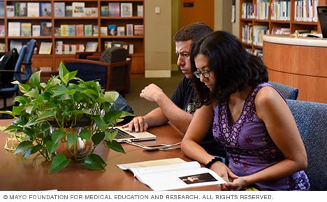 Visitors look over education materials  and staff inside the Stephen and Barbara Slaggie Family Cancer Education Center.