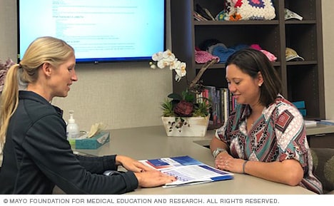 Visitor and staff inside the Juhn Cancer Education room