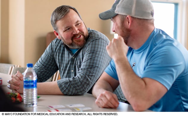 A tobacco cessation counselor monitors someone using a carbon monoxide screening device.