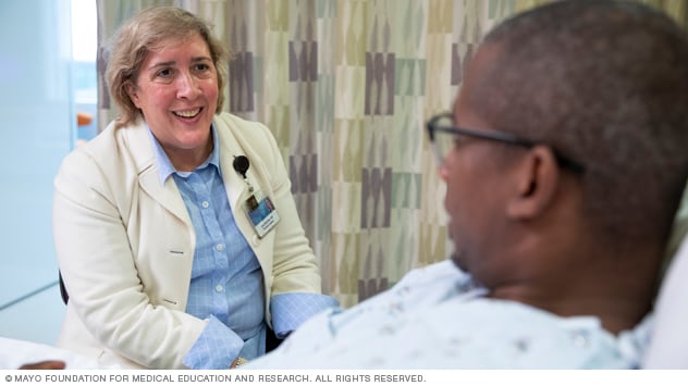 A patient talks with a doctor before a procedure