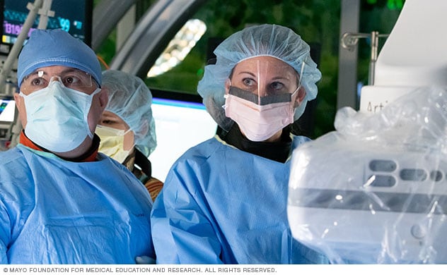 Interventional radiologists perform a procedure.