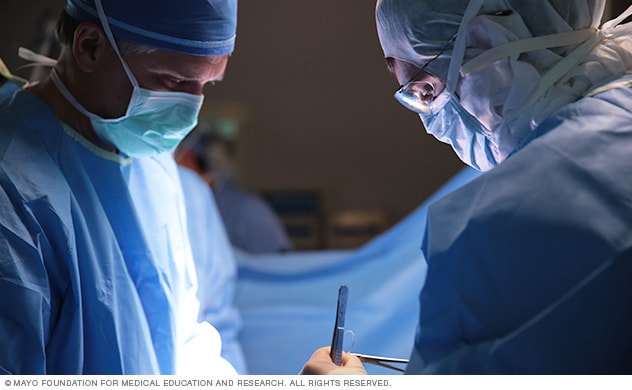 Dos cirujanos realizan un procedimiento y se muestran los instrumentos.