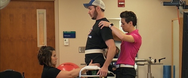 Staff in the Spinal Cord Injury Rehabilitation Program work with a participant.