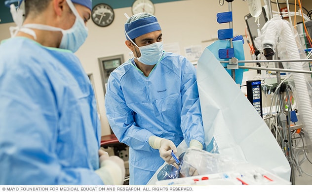 Anesthesiology specialists apply an epidural.