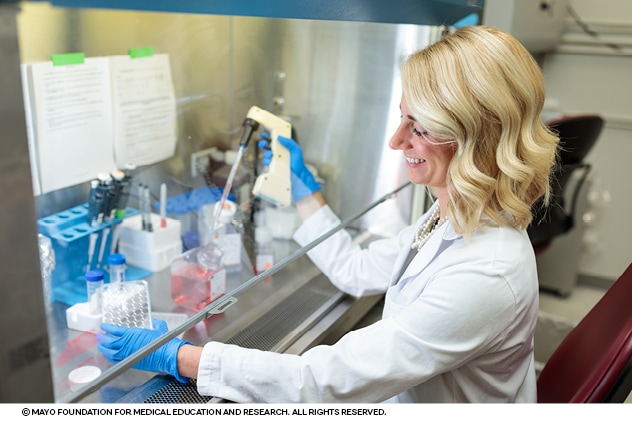 A researcher fills test tubes in a lab dedicated to improving fetal and maternal health.