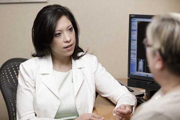 A Mayo Clinic surgical oncologist consults with a patient in her appointment room.