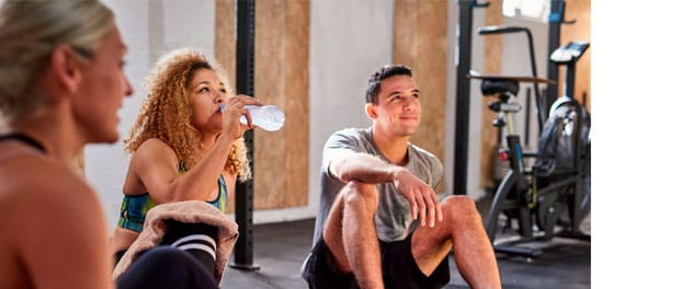 People sitting on floor after exercising.