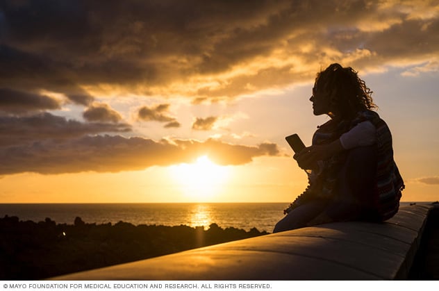 Woman on beach with phone