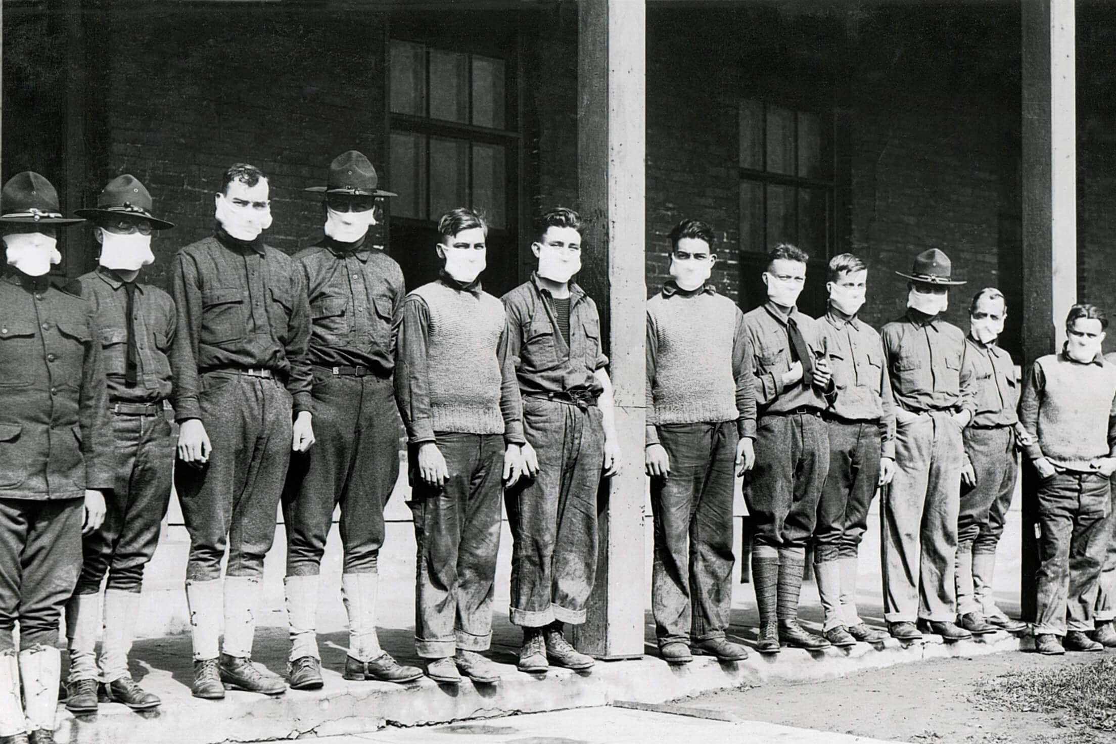 Army men in a line wearing masks at a hospital during the flu pandemic of 1918 and 1919