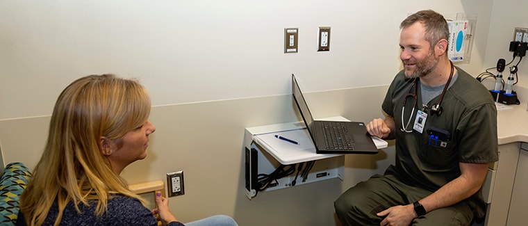 Michael Strum, M.D., talks with a patient