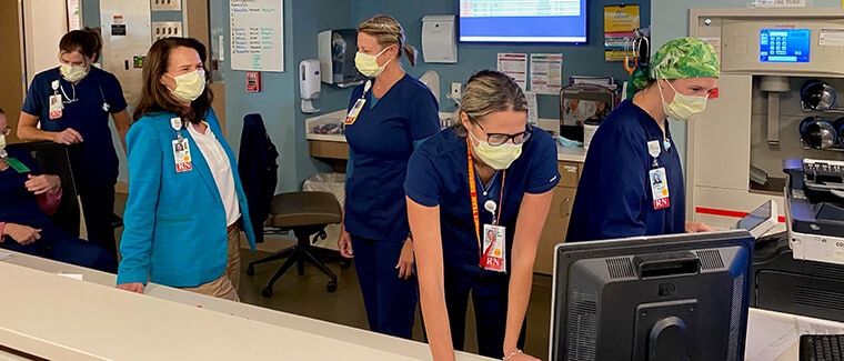 Dr. Carteret Health Care Chief Nursing Officer Patti Hudson consults with her staff.