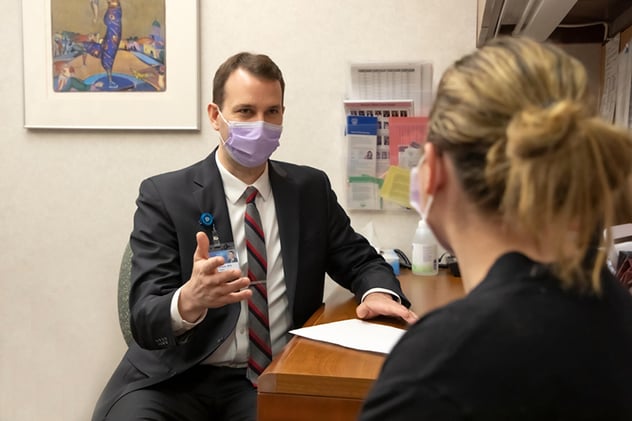 A division surgeon discusses a plan of care with a patient.