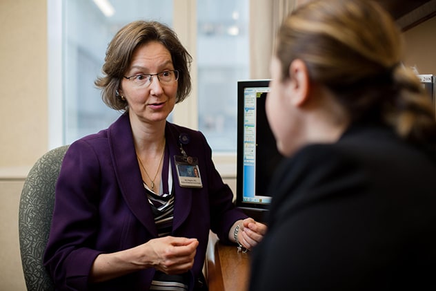 A division surgeon chats in consultation with a patient.