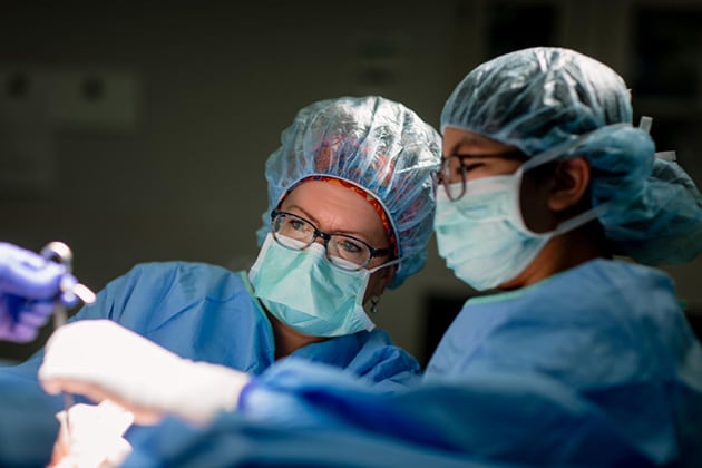 Surgeons conduct an operation.