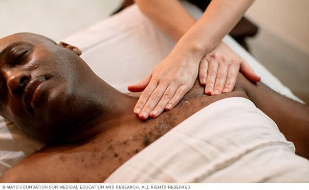 A patient receives acupressure treatment on his shoulder.