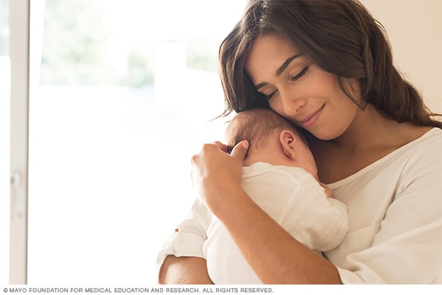 Parent holding baby close to chest