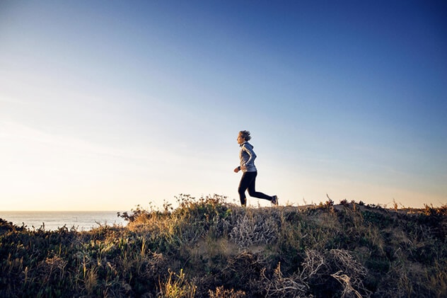 A person runs along a beach.