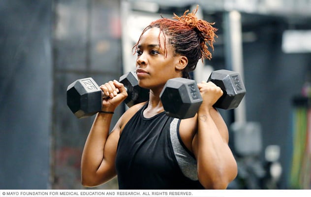 An athlete works out with hand weights.