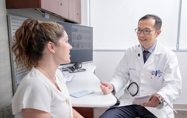 A gynecologist talks with a patient.