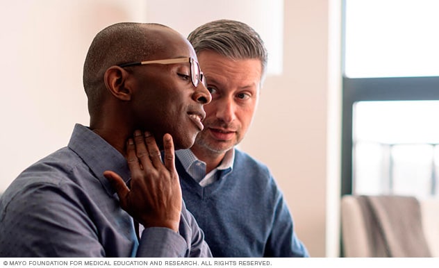 Photo of man checking his pulse over the carotid artery