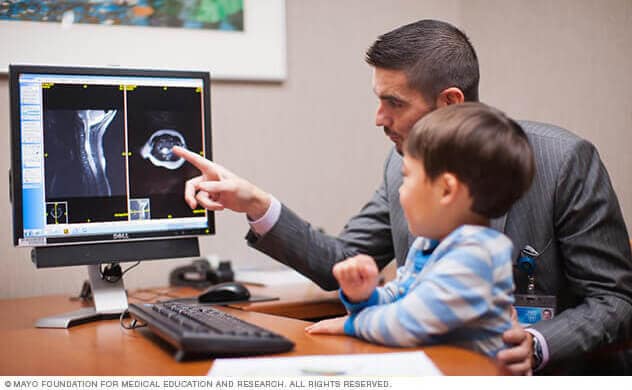 Dr. Daniels with child looking at computer