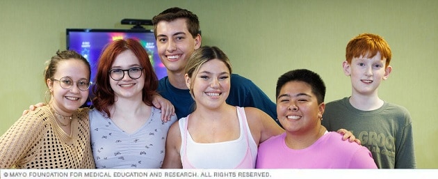 Young people pose together smiling in the Pediatric Pain Rehabilitation Center.