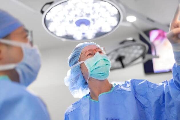 Endocrine surgeons refer to a monitor during a procedure.