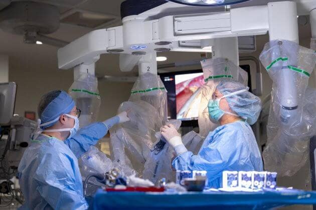 An endocrine surgery team works in a technologically advanced operating room.