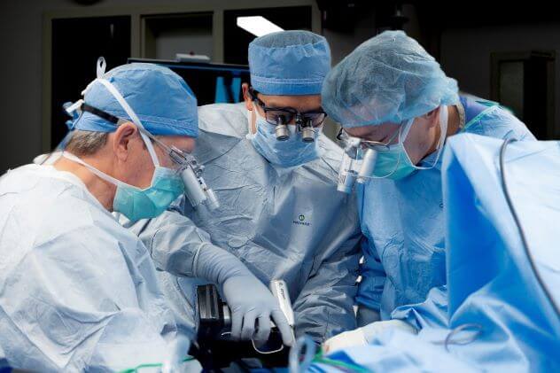 A team of Hand Surgeons performs hand and wrist surgery.