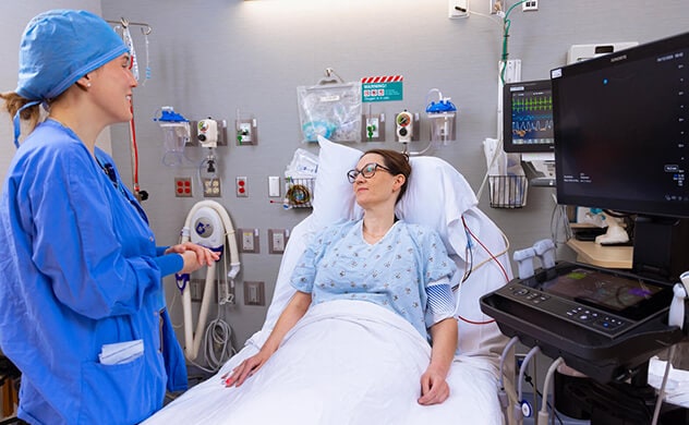 A certified registered nurse anesthetists consults with a patient