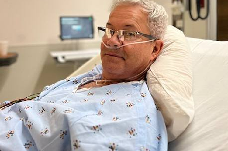 Man appears awake and alert in a hospital bed